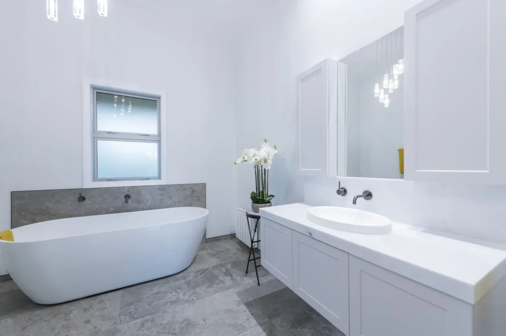 Villa bathroom after renovation with freestanding bath and white vanity