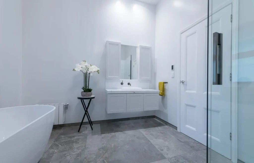 Renovated villa bathroom with walk in shower and freestanding bath