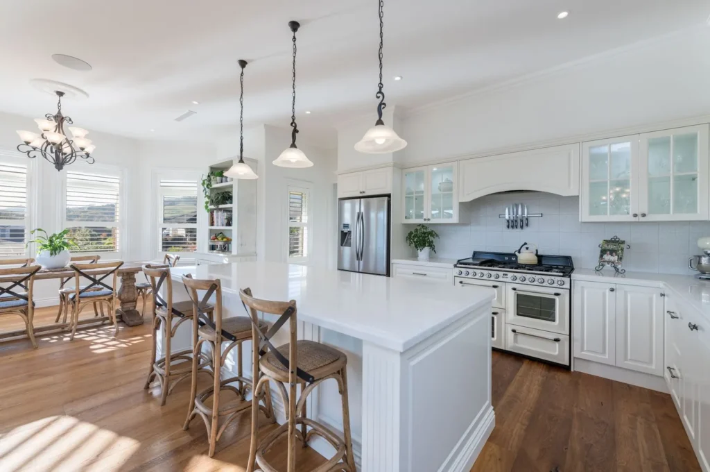 Kitchen with island, range cooker and pendant lights at Marionberry Lane