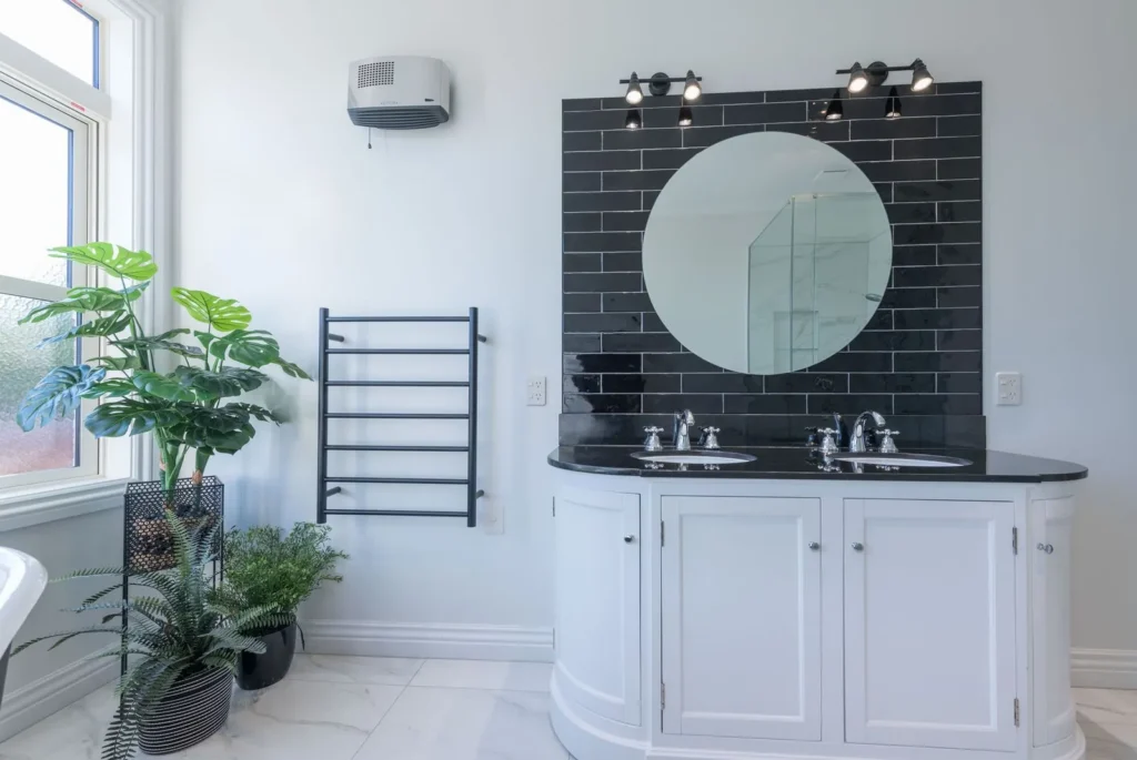 Curved double vanity with black tiled splashback at Marionberry Lane