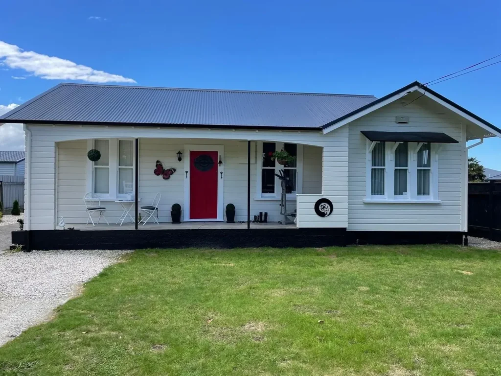 The same cottage after a new roof, cladding repairs and fresh paint