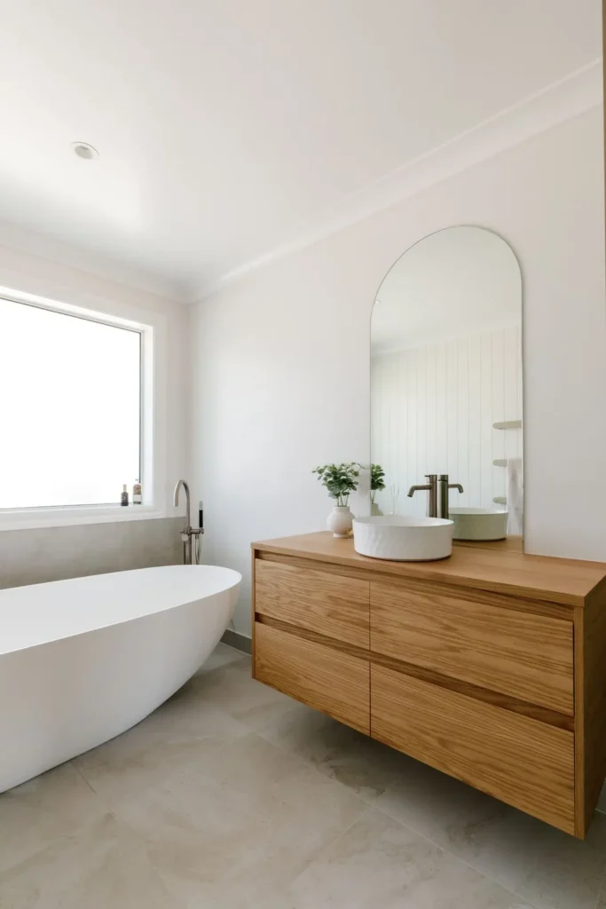 Bathroom with freestanding bath and timber vanity at Redvale Estate