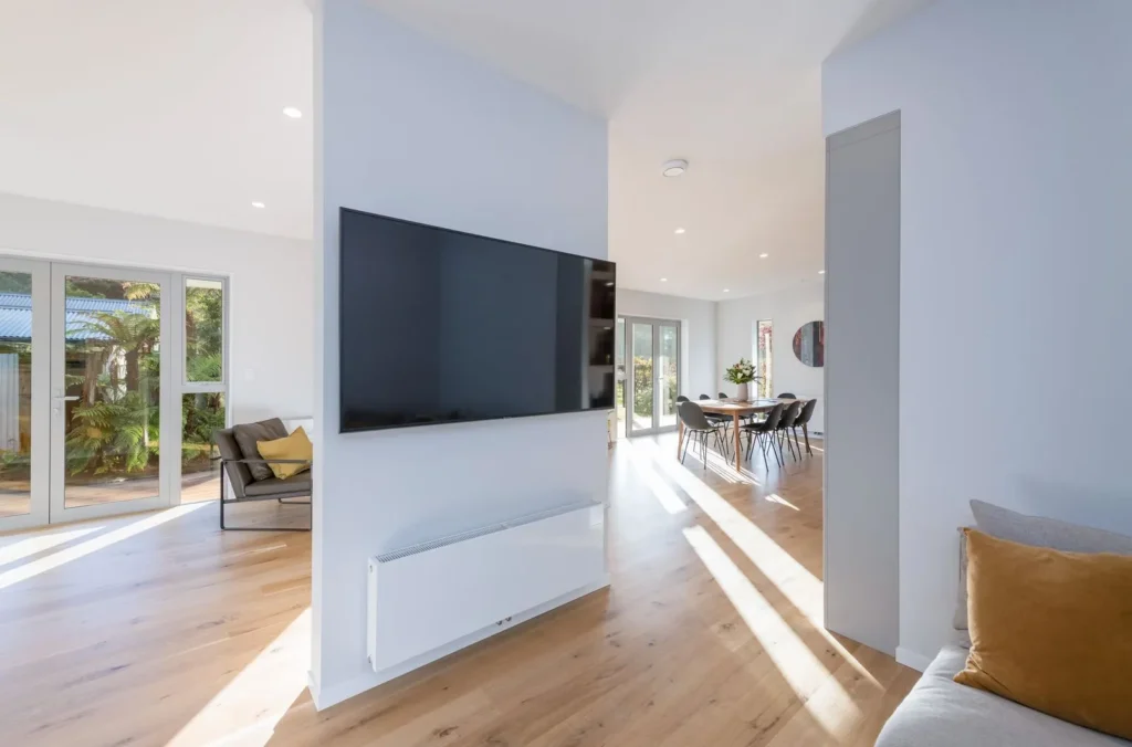 Light filled living room with oak floors in the Takaka Hill renovation
