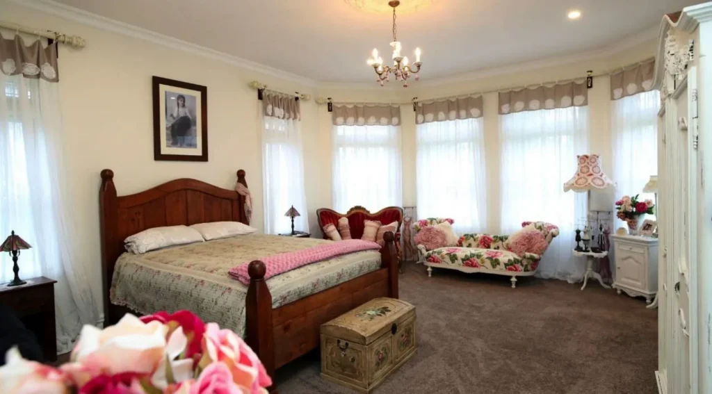 Bedroom with bay windows in the Wakapuaka colonial home